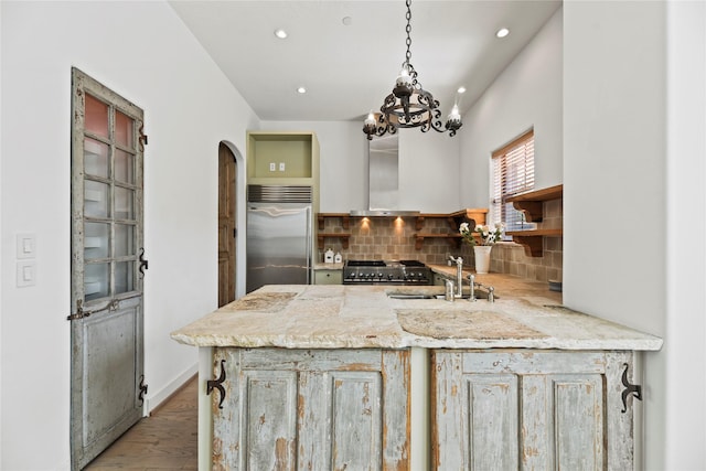 624 Harold St, Houston, TX 77006 - kitchen featuring built in fridge, a sink, stove, recessed lighting, and decorative backsplash