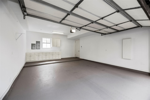 624 Harold St, Houston, TX 77006 - garage with a garage door opener, electric panel, and baseboards