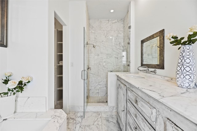 624 Harold St, Houston, TX 77006 - full bathroom with a marble finish shower, double vanity, a spacious closet, and marble finish flooring