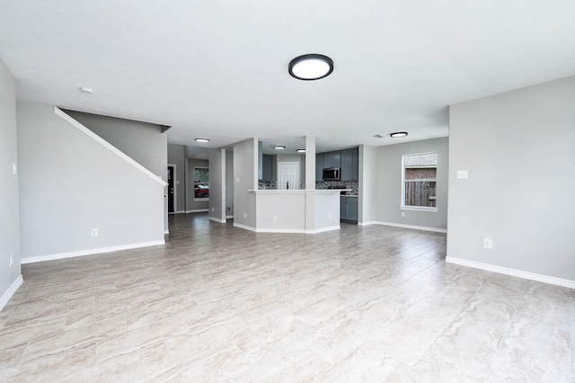 6701 Hidden Colony Ln, League City, TX 77539 - unfurnished living room featuring baseboards