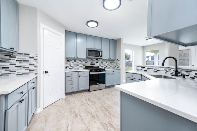 6701 Hidden Colony Ln, League City, TX 77539 - kitchen featuring stainless steel appliances, decorative backsplash, and gray cabinets