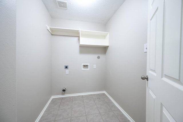 6701 Hidden Colony Ln, League City, TX 77539 - washroom with electric dryer hookup, hookup for a washing machine, light tile patterned floors, and a textured ceiling