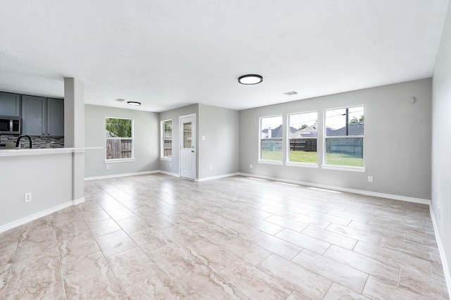 6701 Hidden Colony Ln, League City, TX 77539 - unfurnished living room featuring baseboards