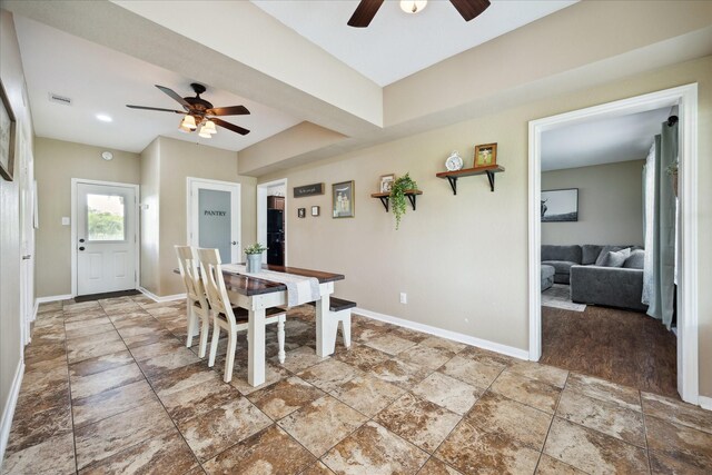 3415 Jack Beaver Rd, Santa Fe, TX 77517 - dining area featuring ceiling fan, baseboards, and stone finish floors