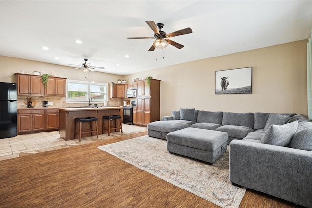 3415 Jack Beaver Rd, Santa Fe, TX 77517 - living room featuring a ceiling fan, recessed lighting, and light wood-style floors