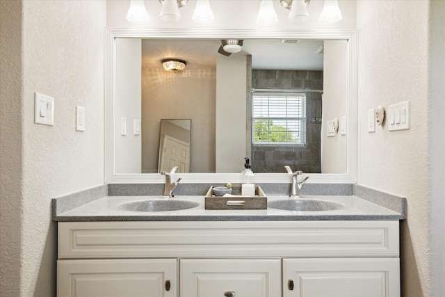 3415 Jack Beaver Rd, Santa Fe, TX 77517 - bathroom with double vanity, a textured wall, and a shower