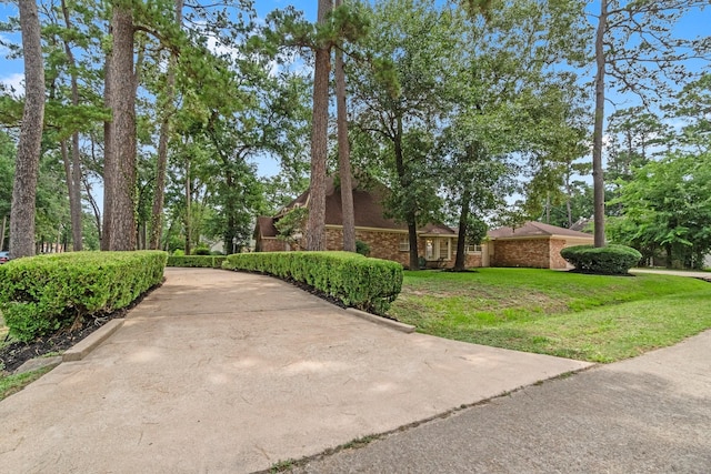 6623 Coral Ridge Rd, Houston, TX 77069 - view of home's exterior with brick siding and a yard