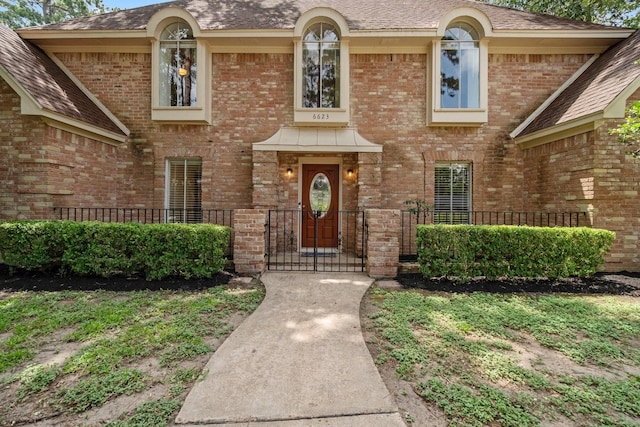 6623 Coral Ridge Rd, Houston, TX 77069 - doorway to property with brick siding, a gate, and a shingled roof