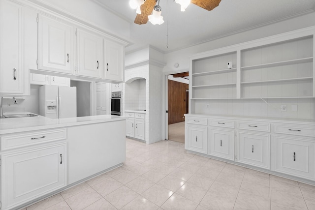 6623 Coral Ridge Rd, Houston, TX 77069 - kitchen featuring a sink, open shelves, white fridge with ice dispenser, stainless steel oven, and white cabinetry