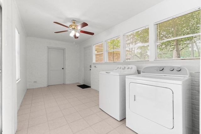 6623 Coral Ridge Rd, Houston, TX 77069 - washroom with independent washer and dryer, a ceiling fan, light tile patterned flooring, and brick wall