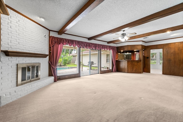 6623 Coral Ridge Rd, Houston, TX 77069 - unfurnished living room featuring carpet floors, a textured ceiling, a fireplace, beam ceiling, and ceiling fan