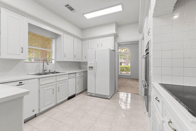 6623 Coral Ridge Rd, Houston, TX 77069 - kitchen featuring white appliances, a sink, light countertops, healthy amount of natural light, and ornamental molding
