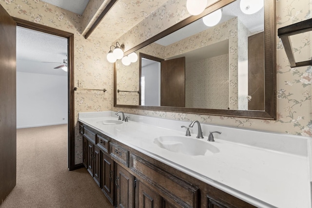 6623 Coral Ridge Rd, Houston, TX 77069 - bathroom with wallpapered walls, double vanity, and ceiling fan