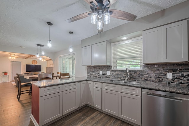 15726 Blackhawk Blvd, Friendswood, TX 77546 - kitchen with dishwasher, a sink, a ceiling fan, a peninsula, and a textured ceiling
