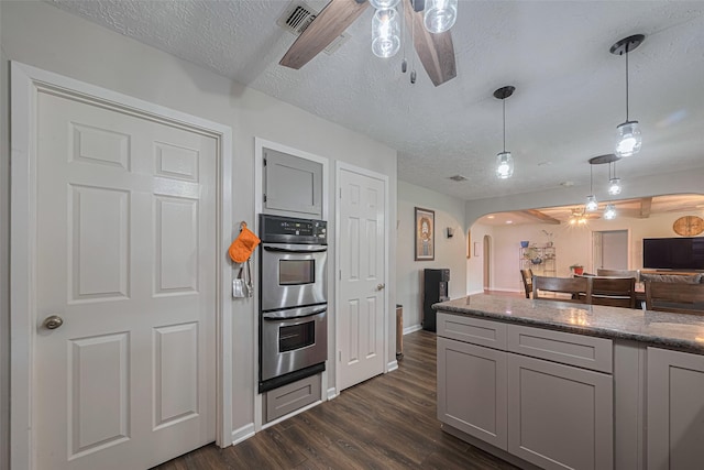15726 Blackhawk Blvd, Friendswood, TX 77546 - kitchen featuring a ceiling fan, arched walkways, double oven, dark wood-style flooring, and a textured ceiling