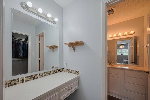 15726 Blackhawk Blvd, Friendswood, TX 77546 - bathroom featuring vanity, a walk in closet, and ceiling fan