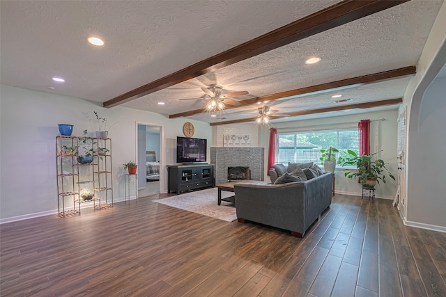 15726 Blackhawk Blvd, Friendswood, TX 77546 - living area featuring a textured ceiling, baseboards, beam ceiling, ceiling fan, and dark wood-type flooring