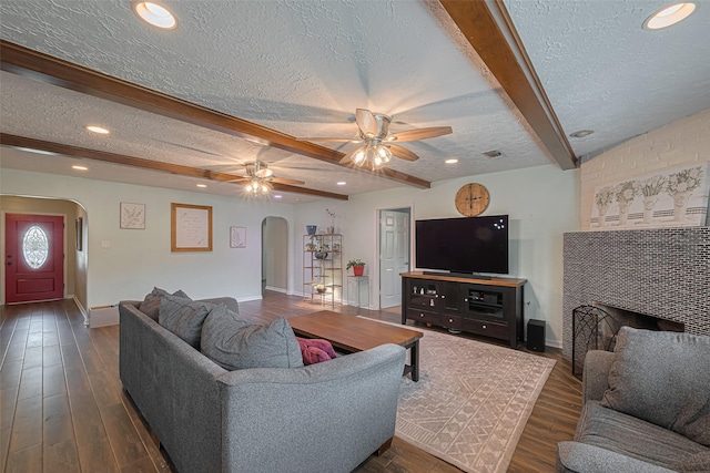 15726 Blackhawk Blvd, Friendswood, TX 77546 - living area with arched walkways, a textured ceiling, beam ceiling, a ceiling fan, and recessed lighting