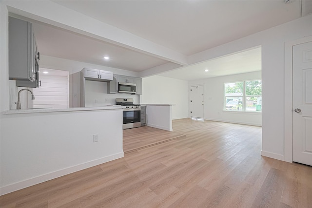 606 Cresline St, Houston, TX 77076 - kitchen with stainless steel appliances, gray cabinetry, light countertops, a peninsula, and recessed lighting