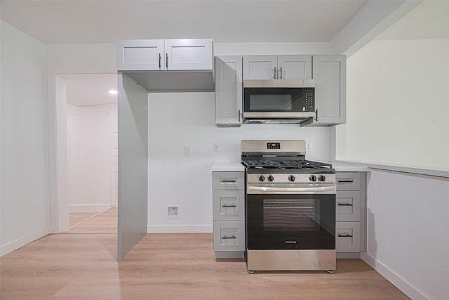 606 Cresline St, Houston, TX 77076 - kitchen featuring appliances with stainless steel finishes, light wood-type flooring, light countertops, and gray cabinets