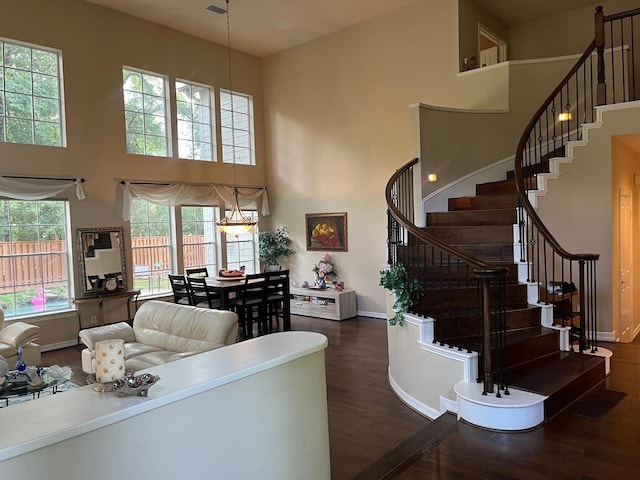 3 Candle Pine Pl, The Woodlands, TX 77381 - living room with a towering ceiling, wood finished floors, baseboards, and stairway