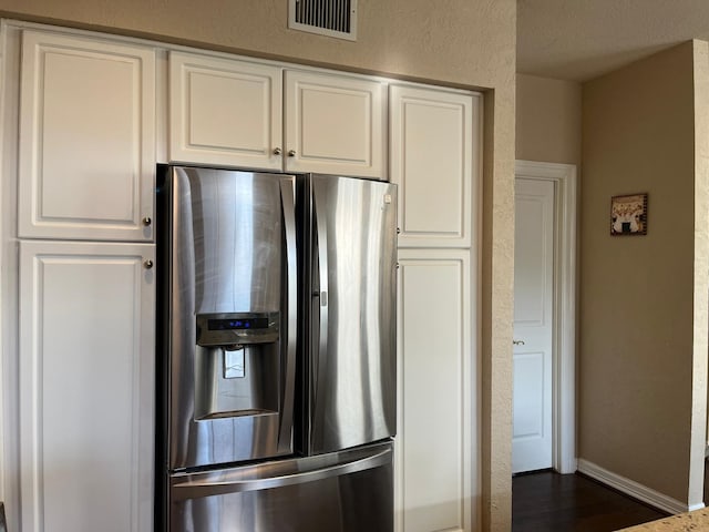 3 Candle Pine Pl, The Woodlands, TX 77381 - kitchen with stainless steel refrigerator with ice dispenser, white cabinetry, dark wood-type flooring, baseboards, and a textured wall