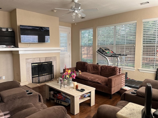 3 Candle Pine Pl, The Woodlands, TX 77381 - living area featuring wood finished floors, a ceiling fan, a premium fireplace, and healthy amount of natural light