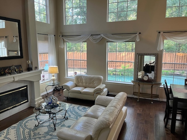 3 Candle Pine Pl, The Woodlands, TX 77381 - living room with plenty of natural light, a high ceiling, hardwood / wood-style floors, and a tile fireplace