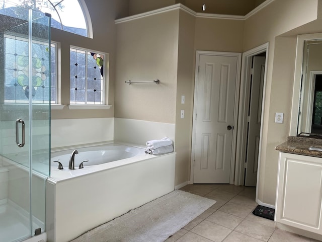 3 Candle Pine Pl, The Woodlands, TX 77381 - full bathroom featuring tile patterned floors, a garden tub, a stall shower, vanity, and baseboards