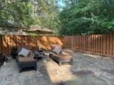 3 Candle Pine Pl, The Woodlands, TX 77381 - fenced backyard with a patio area and a fire pit