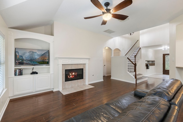 38 Florian Ct, Conroe, TX 77385 - living area with wood finished floors, stairs, ceiling fan, a fireplace, and vaulted ceiling
