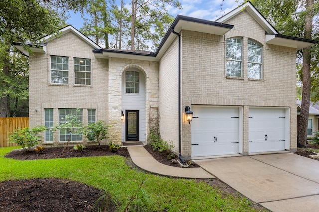 38 Florian Ct, Conroe, TX 77385 - french provincial home with driveway, an attached garage, and brick siding