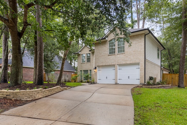 38 Florian Ct, Conroe, TX 77385 - traditional-style home with an attached garage, brick siding, and driveway