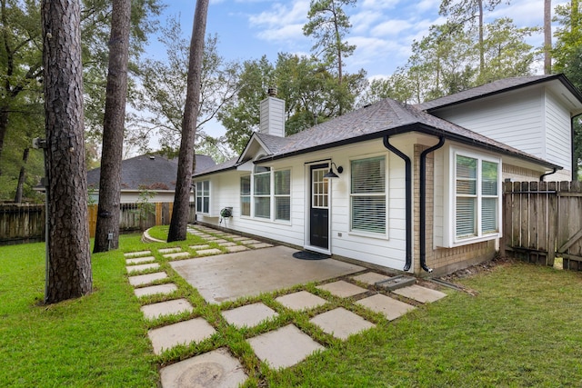 38 Florian Ct, Conroe, TX 77385 - back of property featuring a patio, a chimney, and a shingled roof