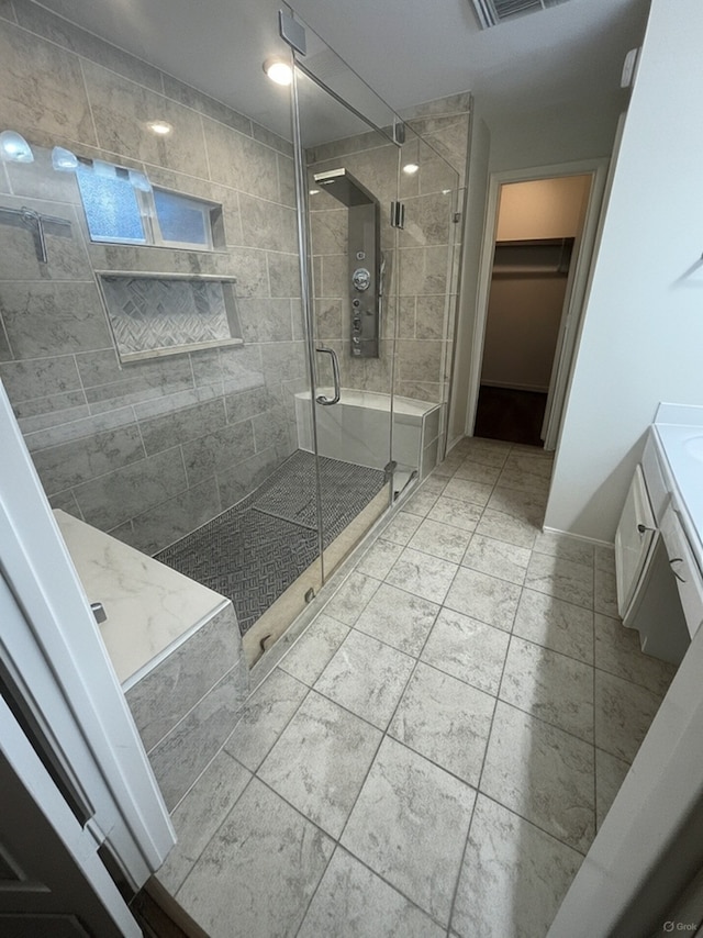 38 Florian Ct, Conroe, TX 77385 - full bathroom with vanity, a shower stall, a spacious closet, and baseboards