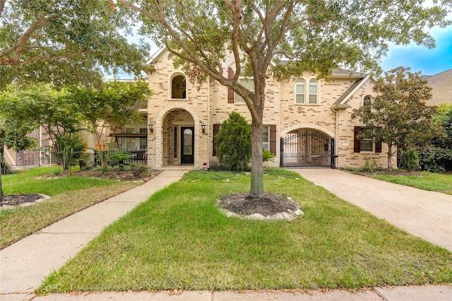 17215 Astrachan Rd, Richmond, TX 77407 - view of front facade with a front yard, a gate, and brick siding