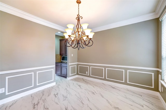 17215 Astrachan Rd, Richmond, TX 77407 - empty room with a decorative wall, a chandelier, crown molding, light marble finish floors, and a wainscoted wall