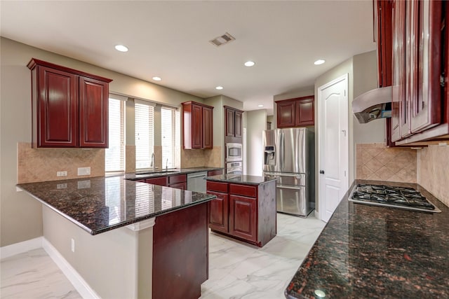 17215 Astrachan Rd, Richmond, TX 77407 - kitchen with stainless steel appliances, light marble finish flooring, dark brown cabinets, a sink, and recessed lighting