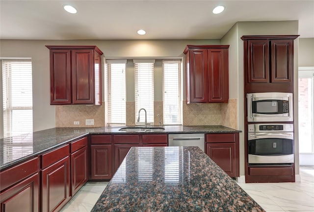 17215 Astrachan Rd, Richmond, TX 77407 - kitchen featuring stainless steel appliances, a sink, dark brown cabinets, and recessed lighting