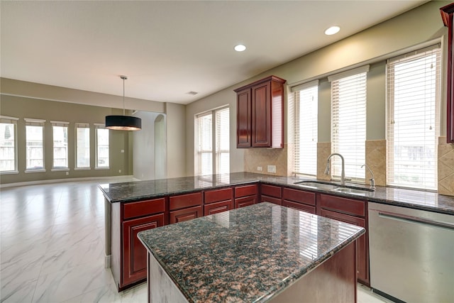 17215 Astrachan Rd, Richmond, TX 77407 - kitchen featuring dishwasher, a peninsula, reddish brown cabinets, a sink, and open floor plan