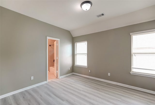17215 Astrachan Rd, Richmond, TX 77407 - empty room featuring light wood finished floors, baseboards, and vaulted ceiling
