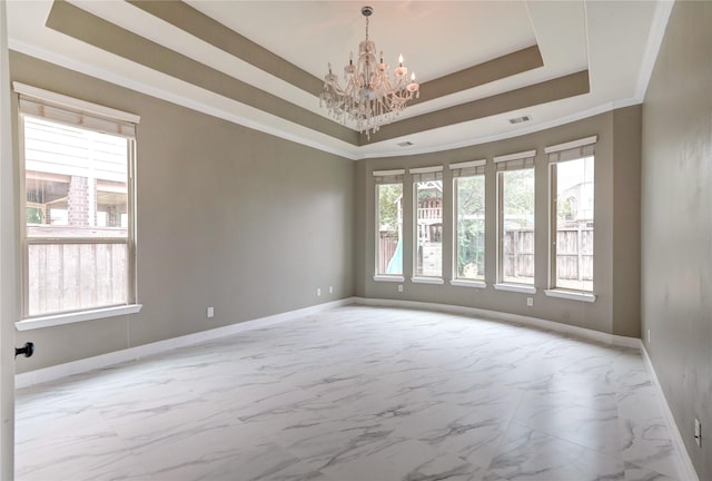 17215 Astrachan Rd, Richmond, TX 77407 - empty room with a chandelier, baseboards, a tray ceiling, light marble finish floors, and ornamental molding
