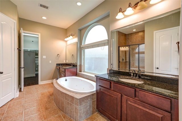 17215 Astrachan Rd, Richmond, TX 77407 - bathroom featuring a stall shower, tile patterned floors, a tub with jets, two vanities, and recessed lighting