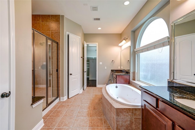 17215 Astrachan Rd, Richmond, TX 77407 - full bath with a shower stall, two vanities, a whirlpool tub, tile patterned flooring, and recessed lighting