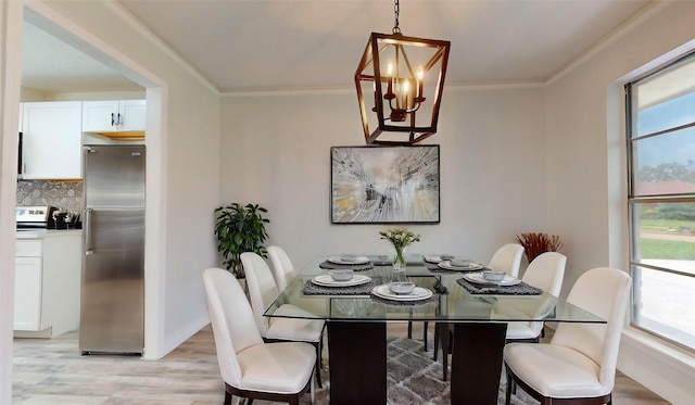 210 Outlook Dr, Houston, TX 77034 - dining room featuring light wood finished floors, ornamental molding, a chandelier, and baseboards