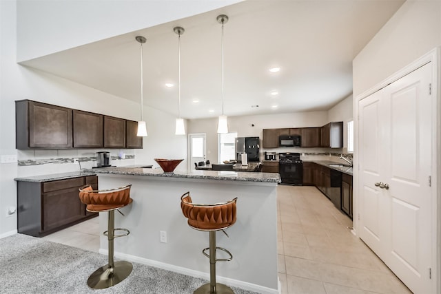 3607 Crosspointe Pass, Angleton, TX 77515 - kitchen with black appliances, a sink, dark brown cabinetry, a kitchen bar, and recessed lighting