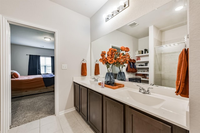 3607 Crosspointe Pass, Angleton, TX 77515 - bathroom with connected bathroom, double vanity, tile patterned floors, baseboards, and a tile shower