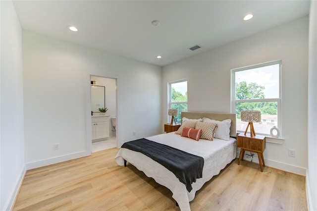 4043 Buck St, Houston, TX 77020 - bedroom with light wood-type flooring, recessed lighting, baseboards, and ensuite bathroom