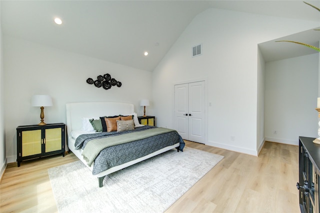 4043 Buck St, Houston, TX 77020 - bedroom with light wood finished floors, high vaulted ceiling, baseboards, recessed lighting, and a closet