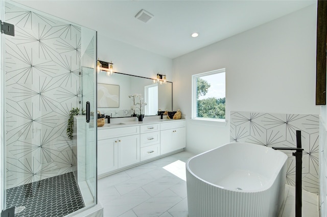 4043 Buck St, Houston, TX 77020 - bathroom featuring a freestanding tub, double vanity, a stall shower, recessed lighting, and marble look tiles
